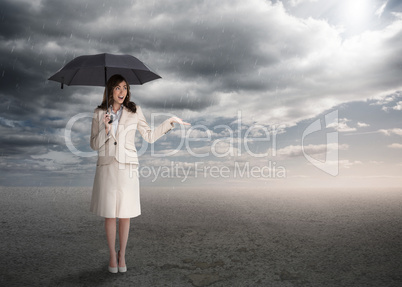 Sophisticated businesswoman holding an umbrella