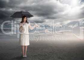 Sophisticated businesswoman holding an umbrella