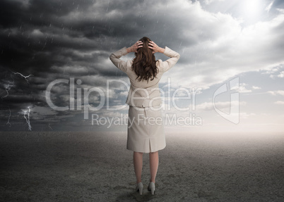 Businesswoman standing in a desert