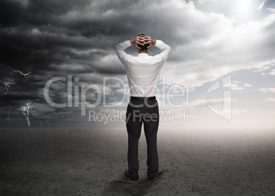 Businessman standing in a desert