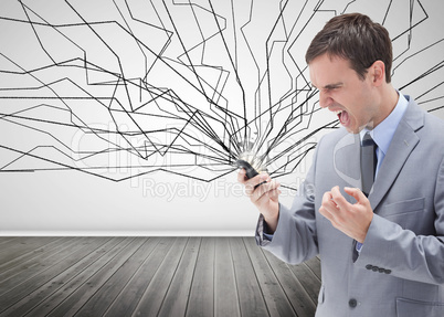Furious businessman looking at his mobile phone