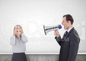 Businessman shouting with a megaphone at his colleague