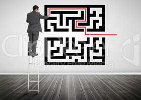 Businessman standing on a ladder drawing line through qr code