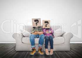 Funny couple wearing boxes with question mark on their head