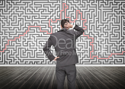 Puzzled businessman looking at a maze