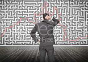 Puzzled businessman looking at a maze