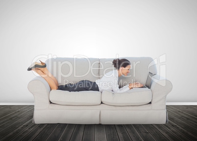 Attractive businesswoman lying on a couch