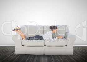 Attractive businesswoman lying on a couch