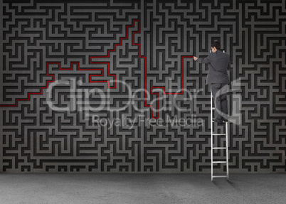 Businessman standing on a ladder and drawing a red line through
