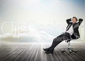 Smiling businessman sitting in a swivel chair