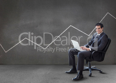 Businessman using his laptop with line on the wall