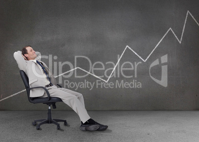 Businessman relaxing in a grey empty room