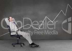 Businessman relaxing in a grey empty room