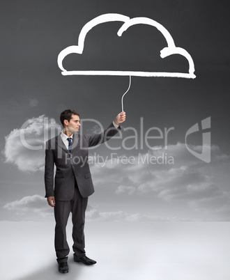 Businessman holding a drawing of a cloud