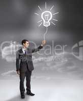 Businessman holding a drawing of a light bulb