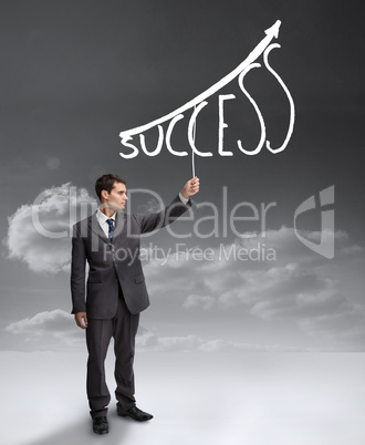 Businessman holding a drawing of a growing chart