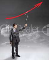 Businessman holding a drawing of a red arrow