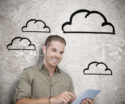 Smiling man using a tablet computer