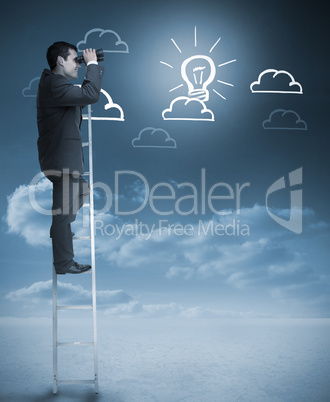 Businessman on a ladder using binoculars