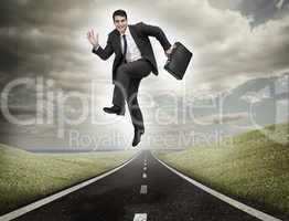 Businessman jumping on a road