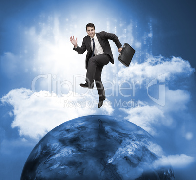 Businessman jumping over a planet