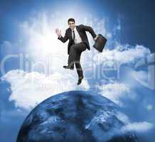 Businessman jumping over a planet