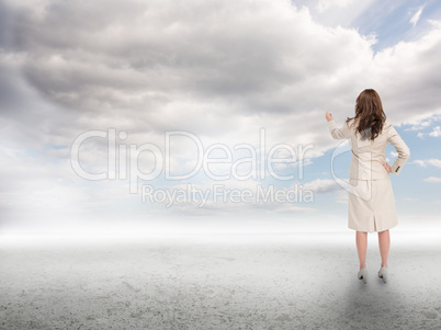 Businesswoman touching at the sky