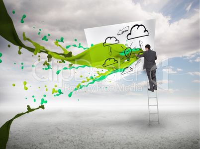 Businessman standing on a ladder with paint splash
