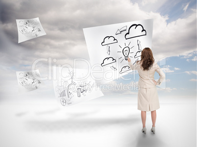 Businesswoman drawing on a floating paper