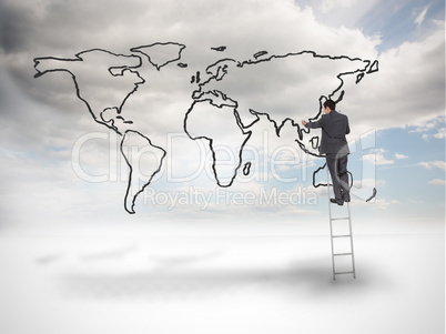 Businessman on a ladder drawing a world map