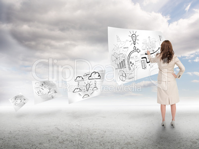 Businesswoman drawing on a paper floating