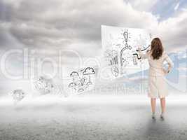 Businesswoman drawing on a paper floating