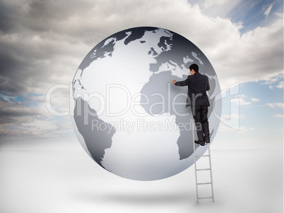 Businessman on a ladder drawing on a planet Businessman on a ladder drawing on a planet