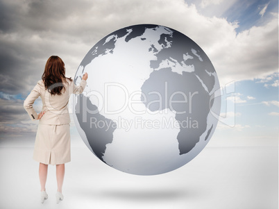 Businesswoman drawing on a planet