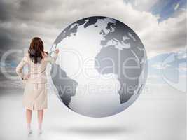 Businesswoman drawing on a planet