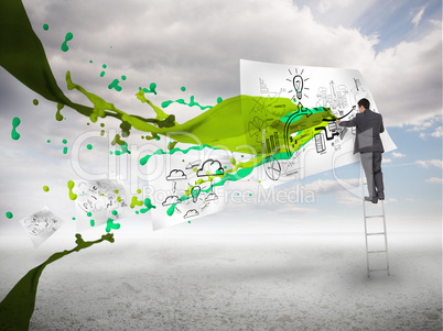 Businessman drawing on a paper next to green paint splash