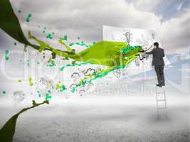 Businessman drawing on a paper next to green paint splash