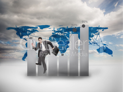Businessman jumping in front of a chart and a world map
