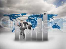 Businessman jumping in front of a chart and a world map