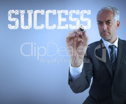 Businessman writing the words success