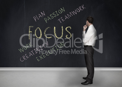 Businessman looking at the word focus