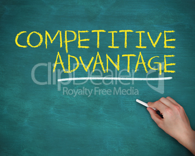 Hand holding a chalk and writing competitive advantage