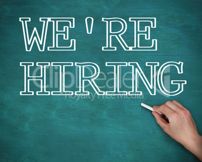 Hand writing we are hiring on green background