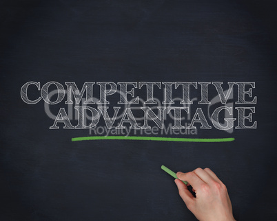 Hand underlining the word competitive advantage in green