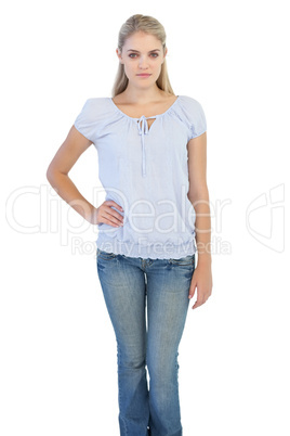 Serious blonde woman with hand on her hip