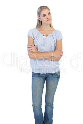 Thinking blonde woman crossing her arms