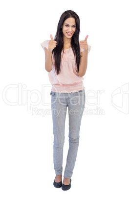 Brunette does thumbs up at camera