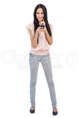 Smiling woman holding mobile phone