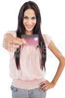 Happy brunette showing her credit card to camera