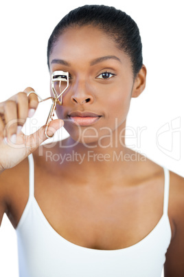 Woman using curler for her eyelash